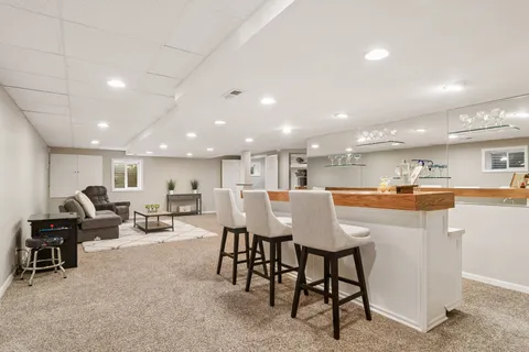 a kitchen with stainless steel appliances kitchen island granite countertop a table and chairs in it
