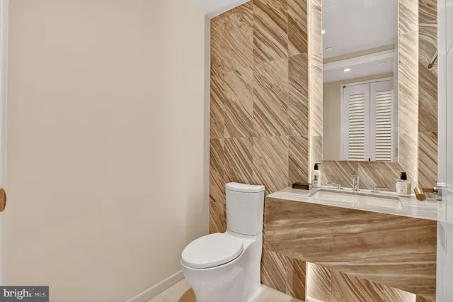 a bedroom with a bed painting on wall and a large window