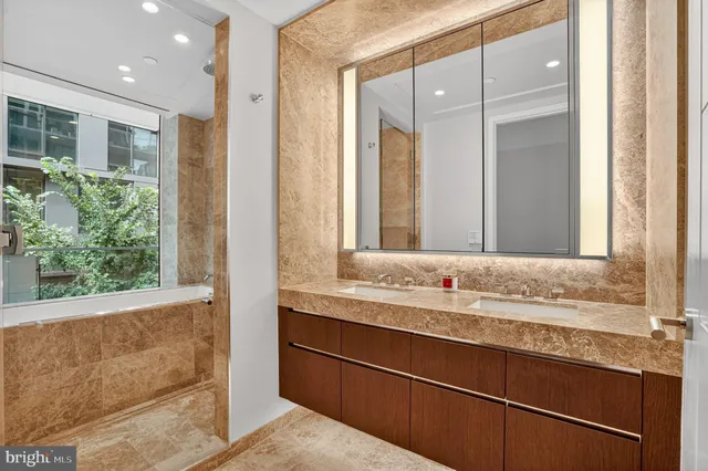 a view of bathroom with bathtub and shower