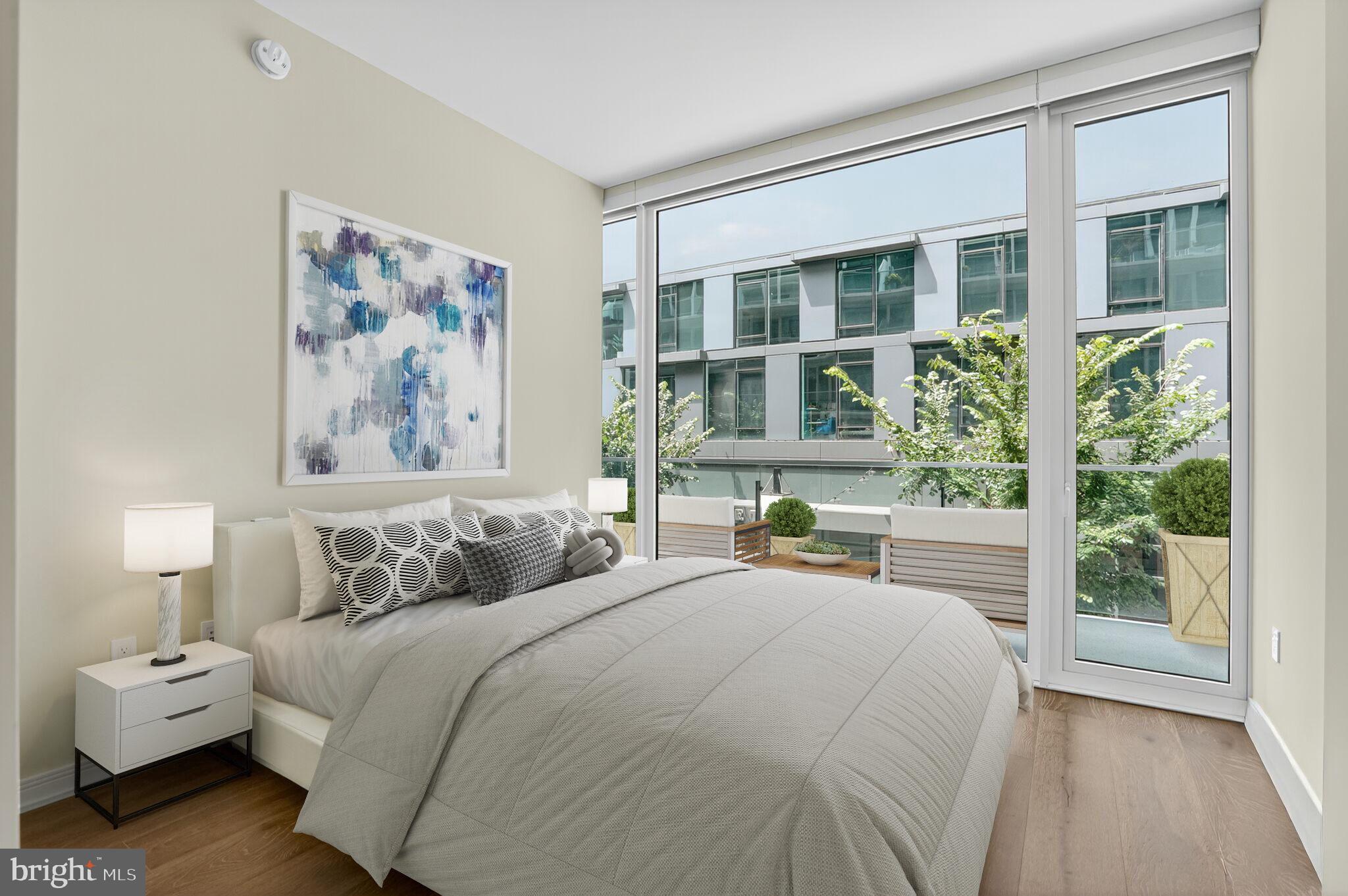 601 Wharf Street Southwest, Unit 213 Washington, DC 20024 - Photo 15 of 24 a bedroom with a large bed and a window