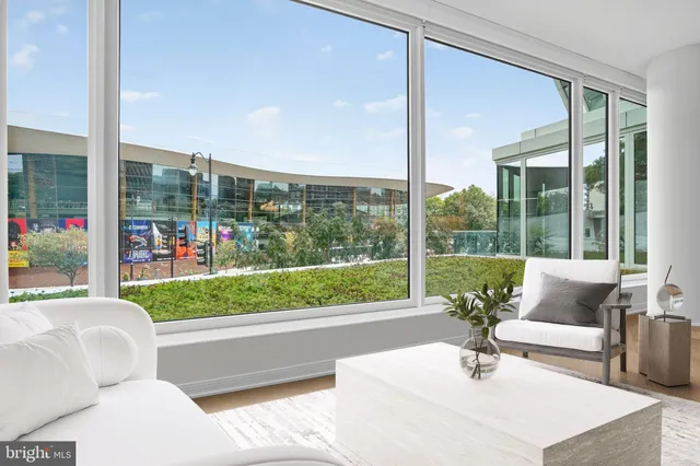 a living room with couch and a floor to ceiling window