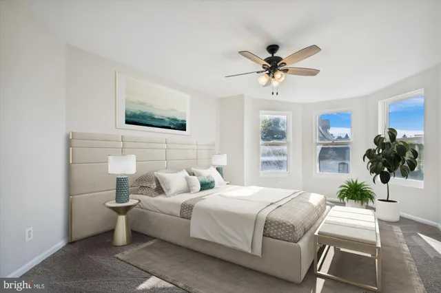 a bedroom with a bed couch and window