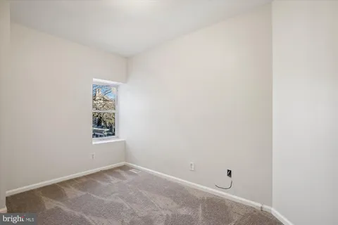 a view of an empty room and a window