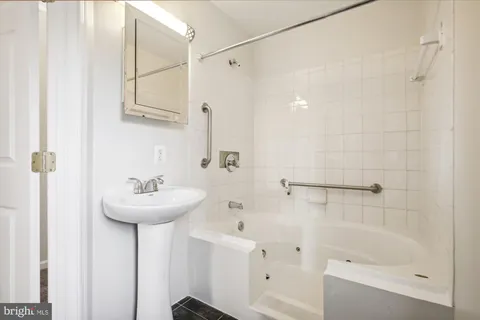 a bathroom with a sink a mirror and a shower