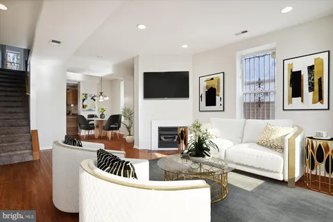 a living room with fireplace furniture and a flat screen tv