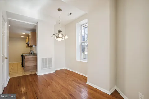a view of a room with wooden floor and staircase
