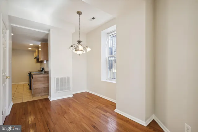 a view of a room with wooden floor and staircase
