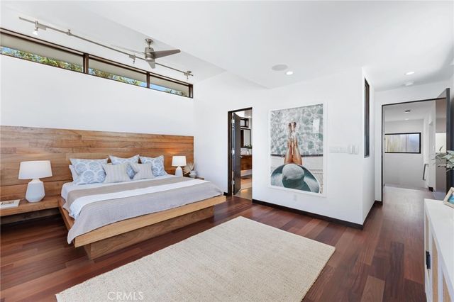 a bedroom with a bed and a painting on the wall