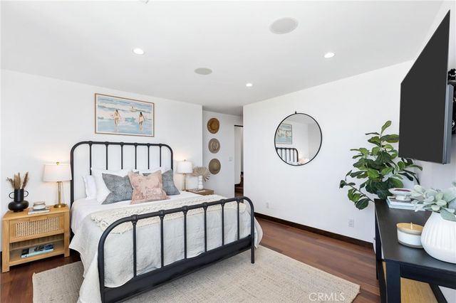 a bedroom with a large bed and a large window