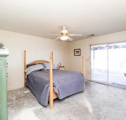 21780 Valley View Road Madera, CA 93638 - Photo 15 of 22 a bedroom with a bed and a chandelier