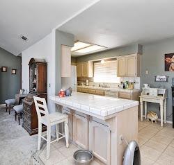 21780 Valley View Road Madera, CA 93638 - Photo 7 of 22 a room with stainless steel appliances kitchen island granite countertop a sink and cabinets