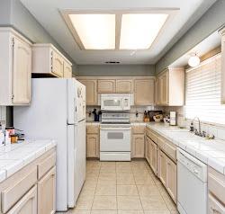 21780 Valley View Road Madera, CA 93638 - Photo 8 of 22 a kitchen with white cabinets and white appliances
