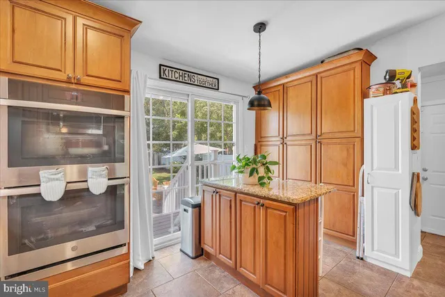 a kitchen with windows and refrigerator