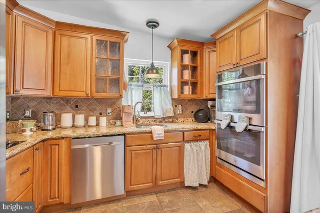 a kitchen with stainless steel appliances granite countertop a stove and a refrigerator