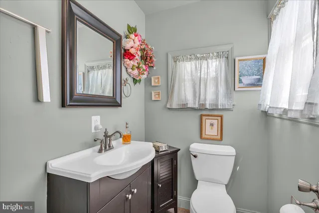 a bathroom with a toilet sink and mirror