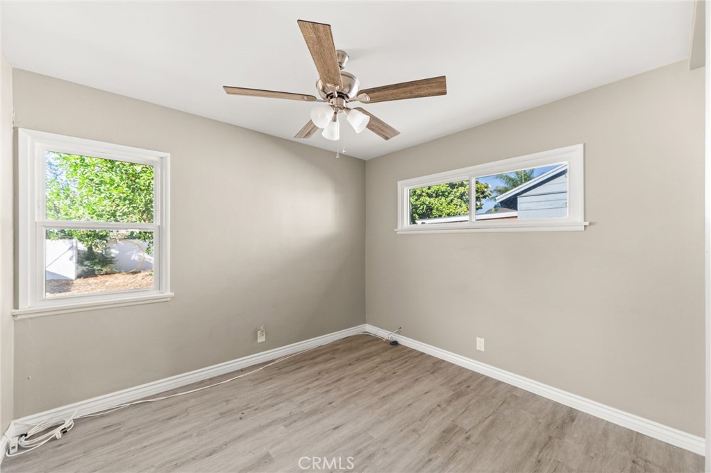 3869 Shamrock Avenue Riverside, CA 92501 - Photo 12 of 34 a view of an empty room with wooden floor and a window