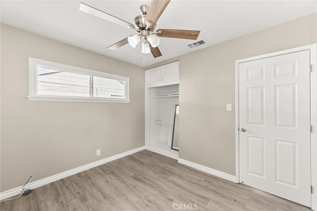 3869 Shamrock Avenue Riverside, CA 92501 - Photo 13 of 34 an empty room with wooden floor fan and windows