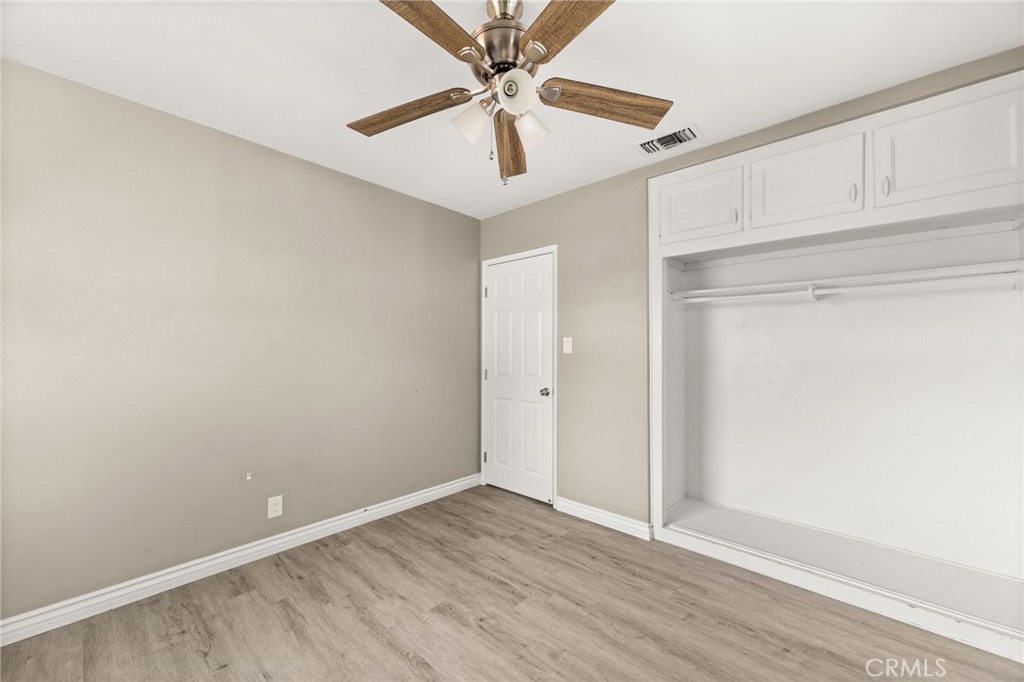 3869 Shamrock Avenue Riverside, CA 92501 - Photo 16 of 34 a view of an empty room with window and a ceiling fan