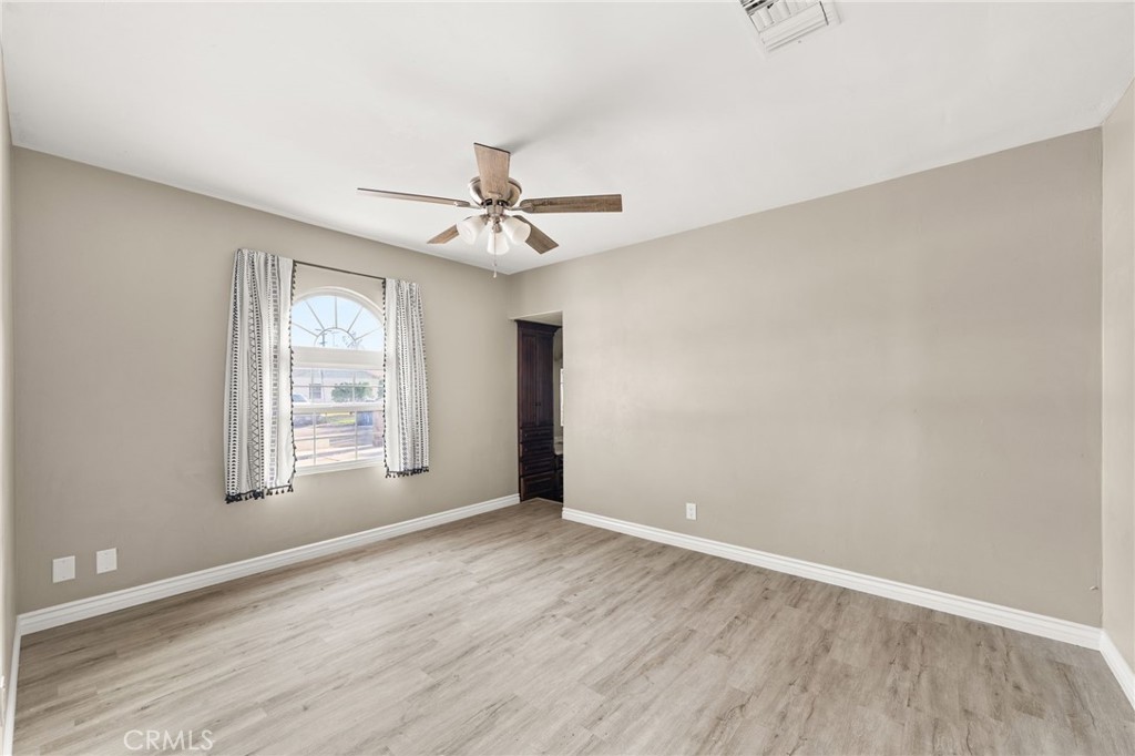 3869 Shamrock Avenue Riverside, CA 92501 - Photo 17 of 34 wooden floor in an empty room with a window