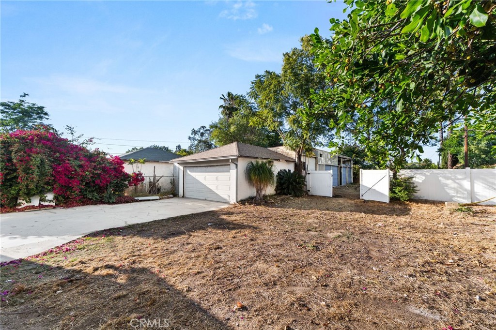 3869 Shamrock Avenue Riverside, CA 92501 - Photo 27 of 34 a front view of a house with a yard and garage