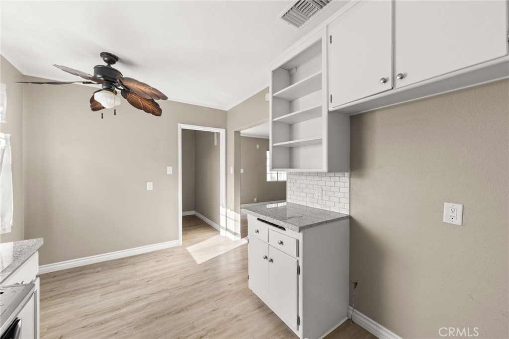 3869 Shamrock Avenue Riverside, CA 92501 - Photo 7 of 34 a kitchen with cabinets and wooden floor