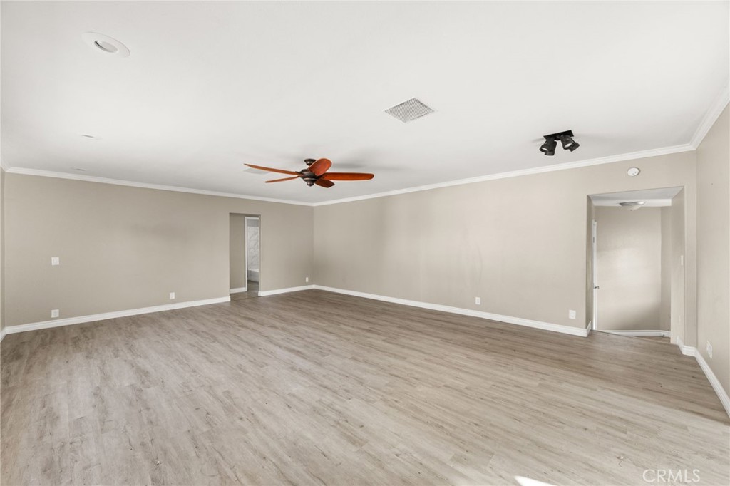 3869 Shamrock Avenue Riverside, CA 92501 - Photo 10 of 34 an empty room with wooden floor and windows