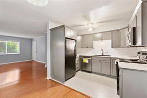 1822 North Rock Springs Road Northeast, Unit 7 Atlanta, GA 30324 - Photo 8 of 21 a kitchen with stainless steel appliances granite countertop a refrigerator and a sink