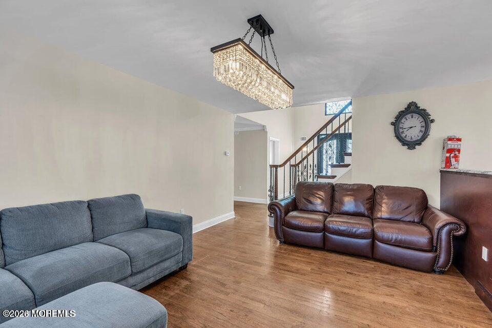 60 Bowman Road Jackson, NJ 08527 - Photo 11 of 68 a living room with furniture a clock and a ceiling fan