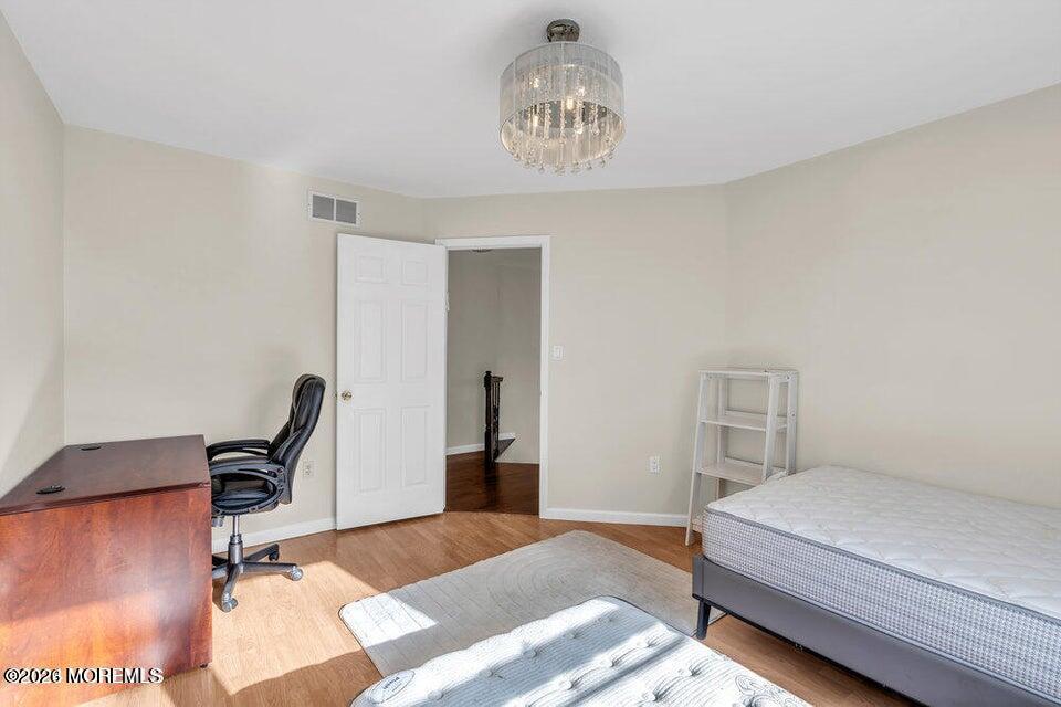 60 Bowman Road Jackson, NJ 08527 - Photo 13 of 68 a bedroom with a bed and a chandelier