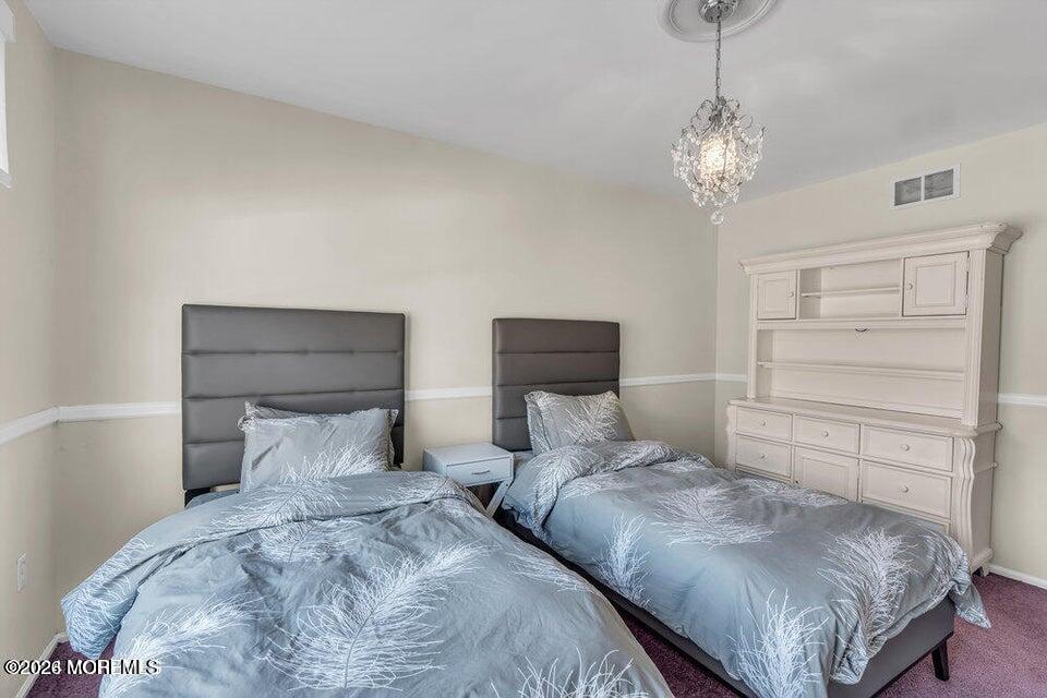 60 Bowman Road Jackson, NJ 08527 - Photo 48 of 68 a bedroom with a bed and a chandelier