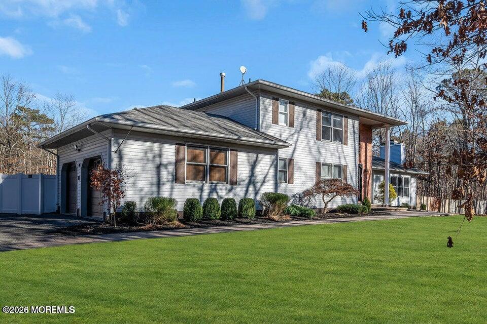 60 Bowman Road Jackson, NJ 08527 - Photo 61 of 68 a front view of a house with a yard table and chairs