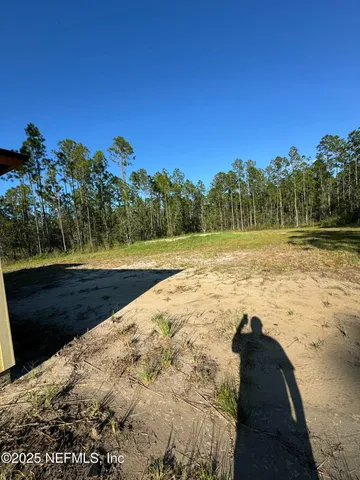 a view of a porch with a table and chairs