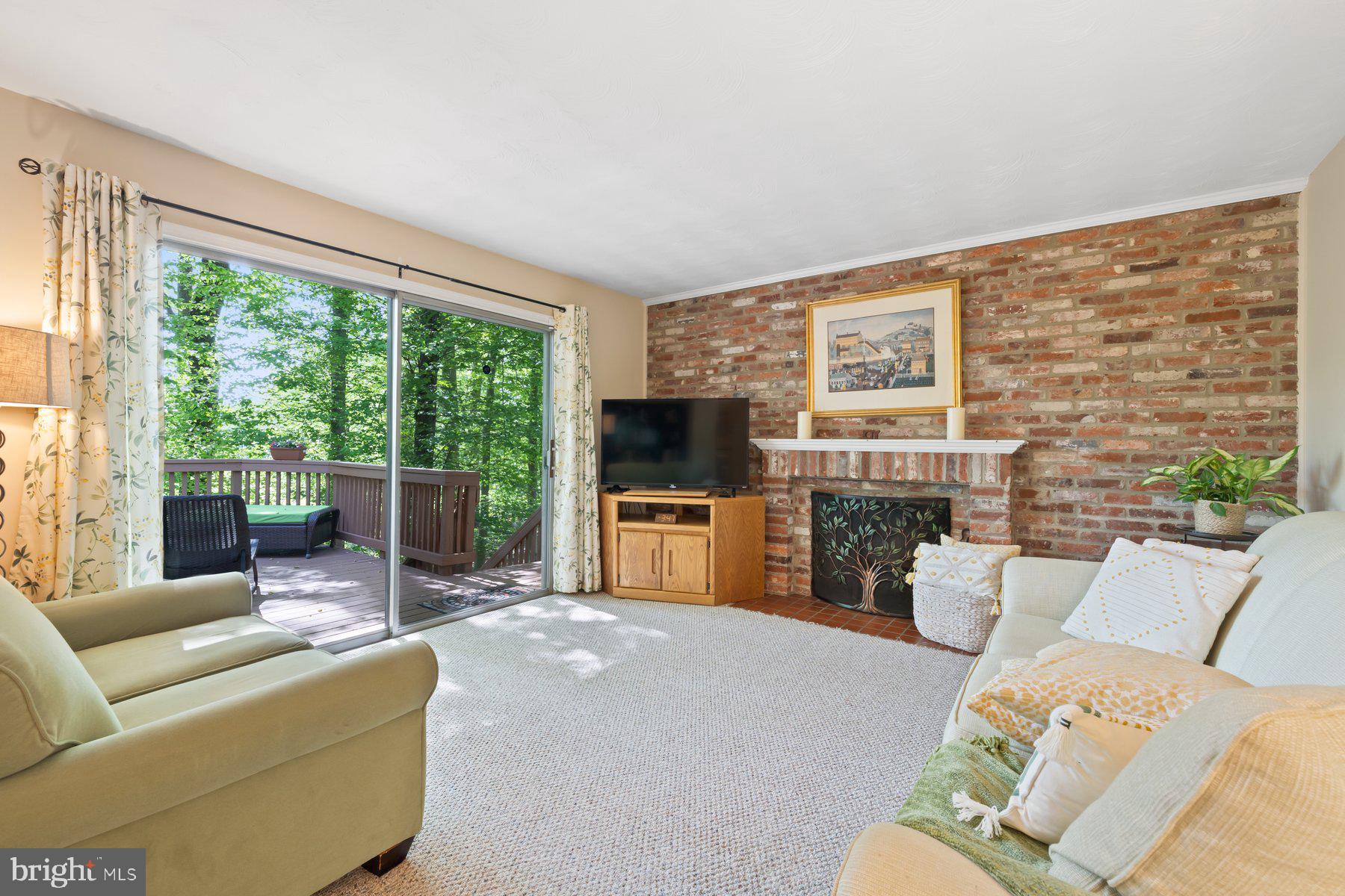 13820 Flint Rock Road Rockville, MD 20853 - Photo 11 of 50 a living room with furniture floor to ceiling window hardwood floor and a flat screen tv