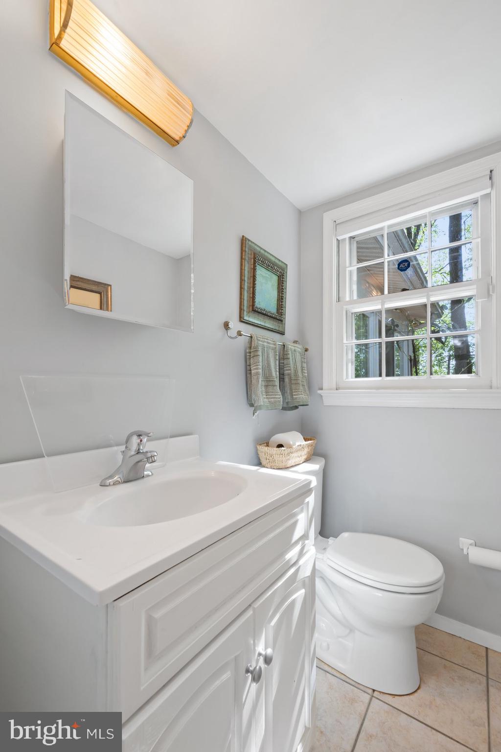 13820 Flint Rock Road Rockville, MD 20853 - Photo 15 of 50 a bathroom with a sink a toilet and a window