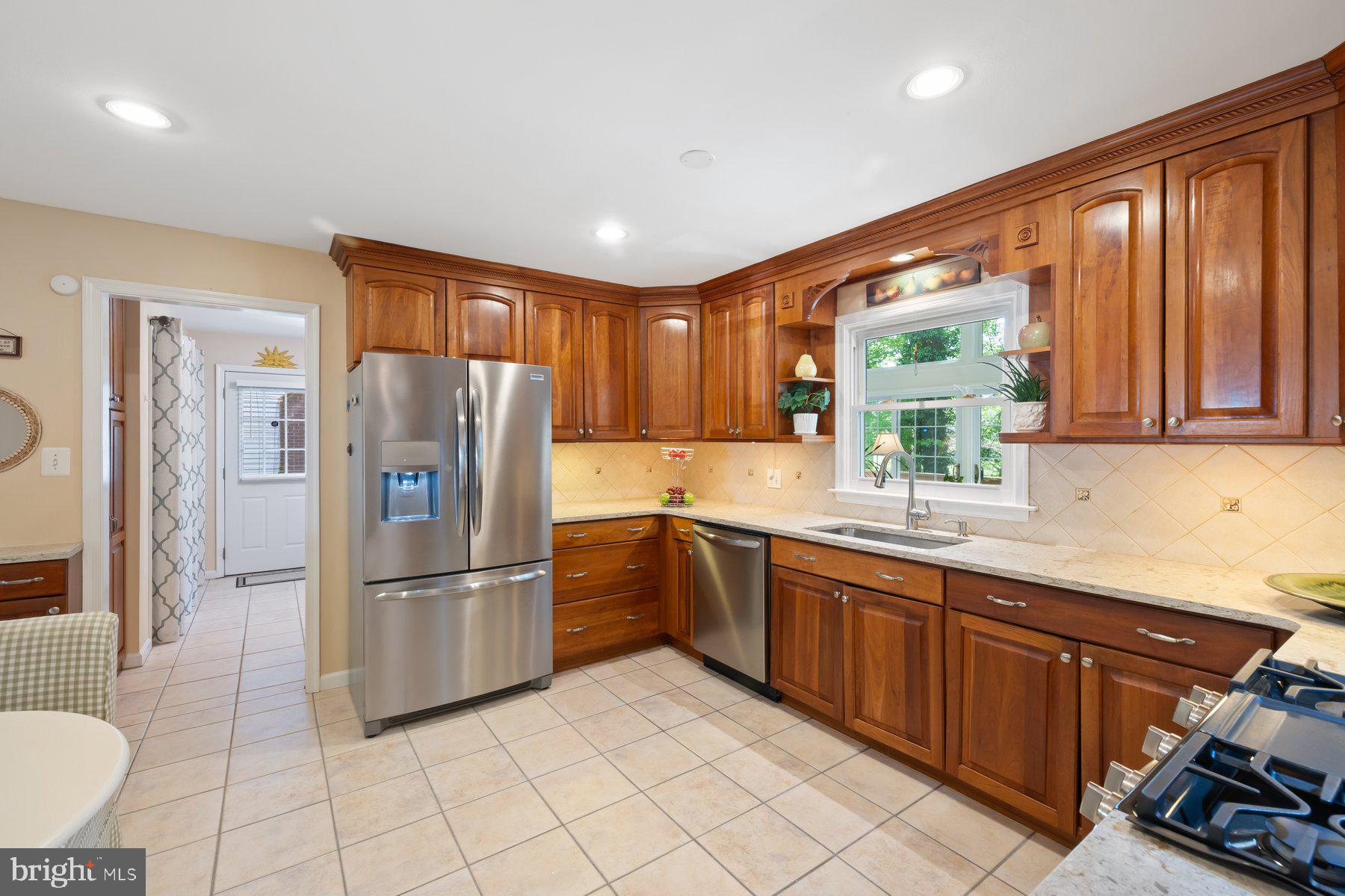 13820 Flint Rock Road Rockville, MD 20853 - Photo 16 of 50 a kitchen with stainless steel appliances granite countertop a refrigerator and a sink