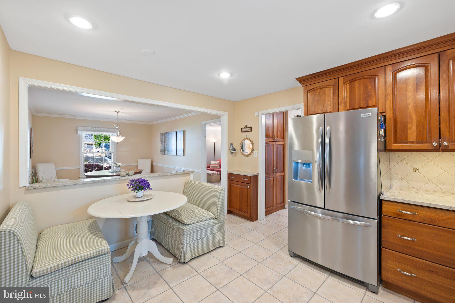 13820 Flint Rock Road Rockville, MD 20853 - Photo 17 of 50 a kitchen with stainless steel appliances a refrigerator and dining table