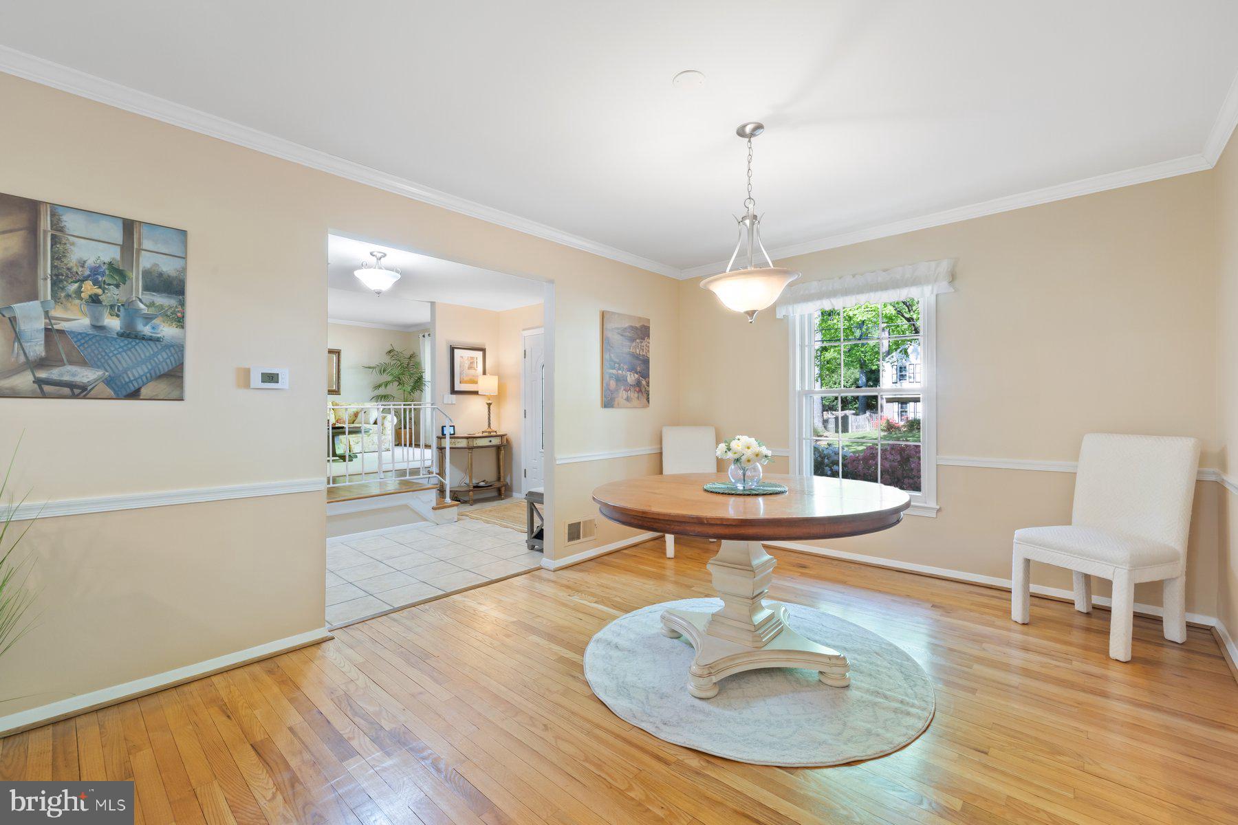 13820 Flint Rock Road Rockville, MD 20853 - Photo 21 of 50 a living room with furniture a table and a chandelier
