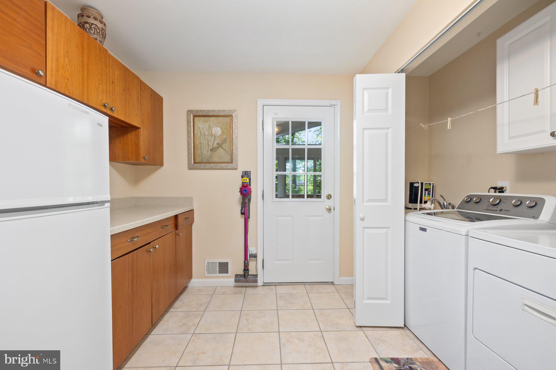 13820 Flint Rock Road Rockville, MD 20853 - Photo 23 of 50 a utility room with cabinets washer and dryer