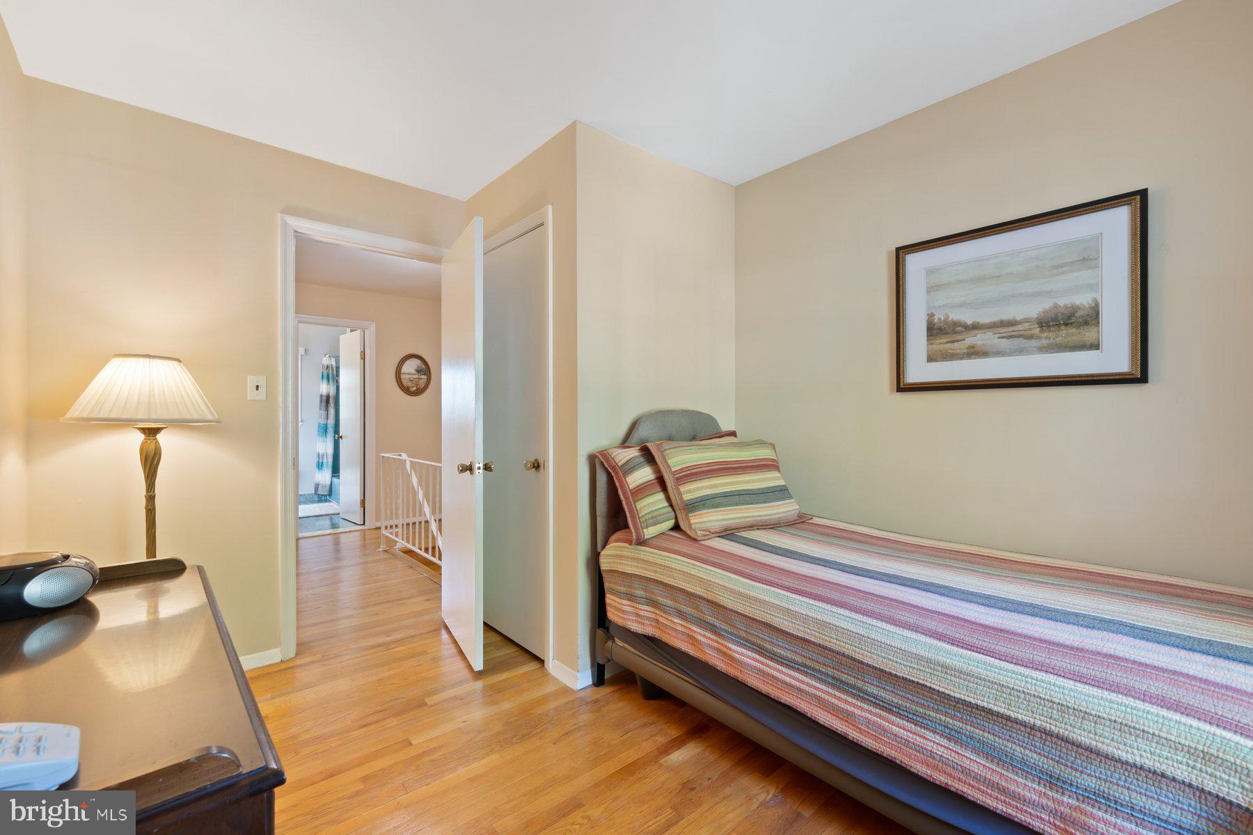 13820 Flint Rock Road Rockville, MD 20853 - Photo 29 of 50 a bedroom with a bed and a lamp on table