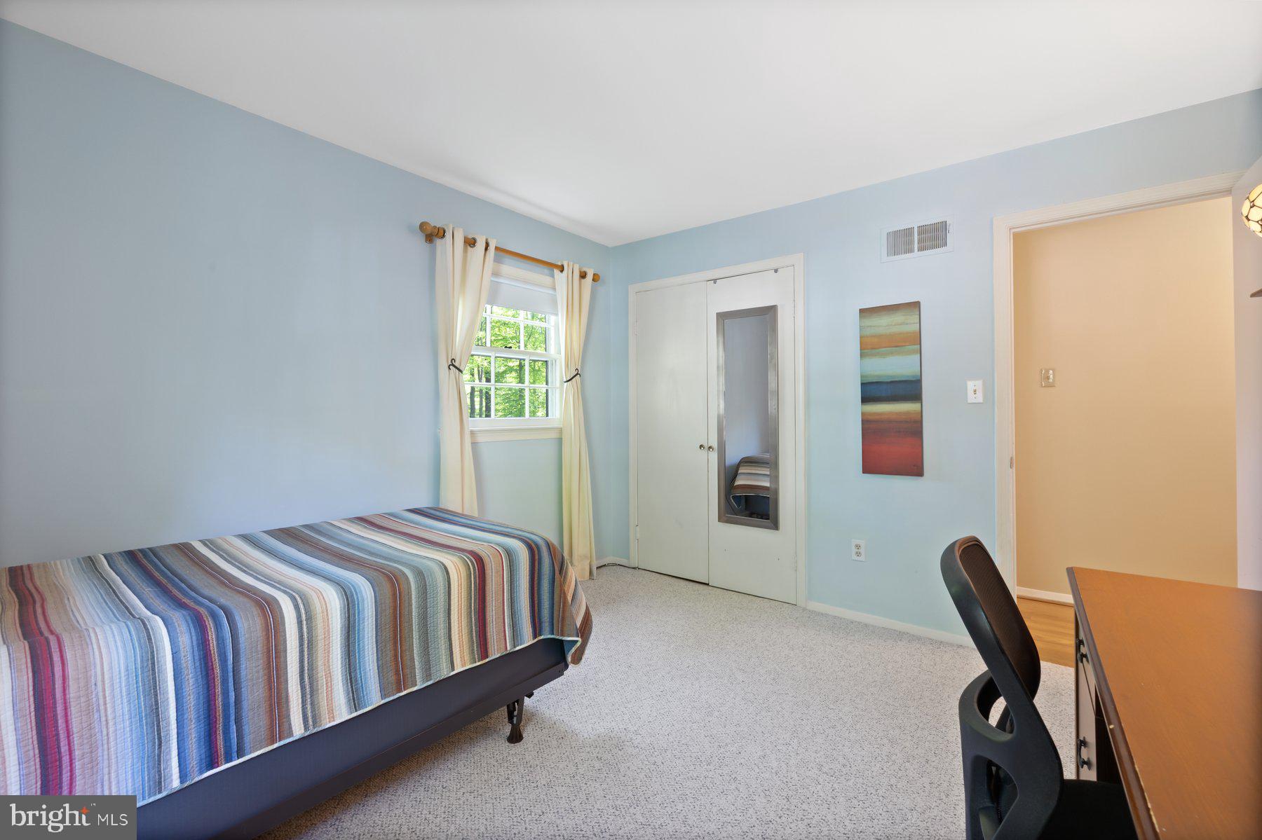 13820 Flint Rock Road Rockville, MD 20853 - Photo 33 of 50 a bedroom with a bed a chair and a window