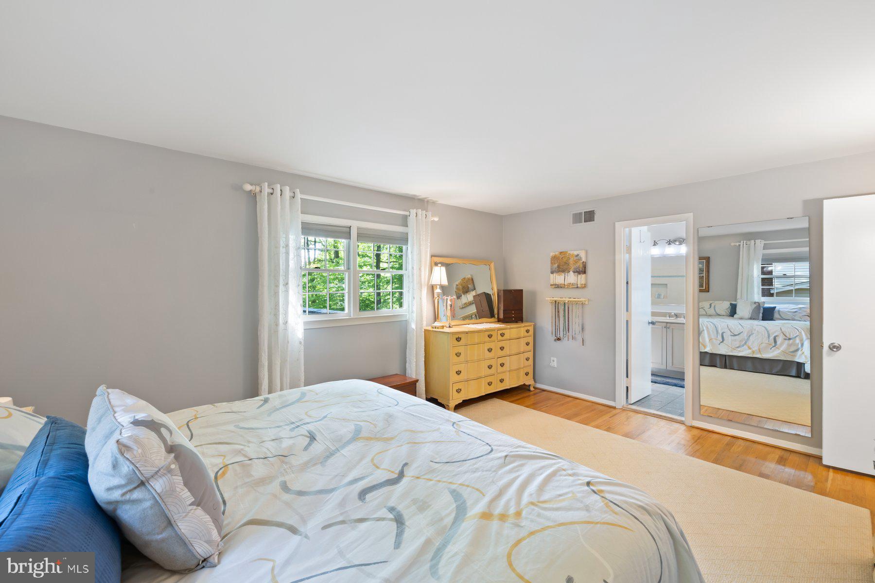 13820 Flint Rock Road Rockville, MD 20853 - Photo 35 of 50 a bedroom with a large bed and wooden floor