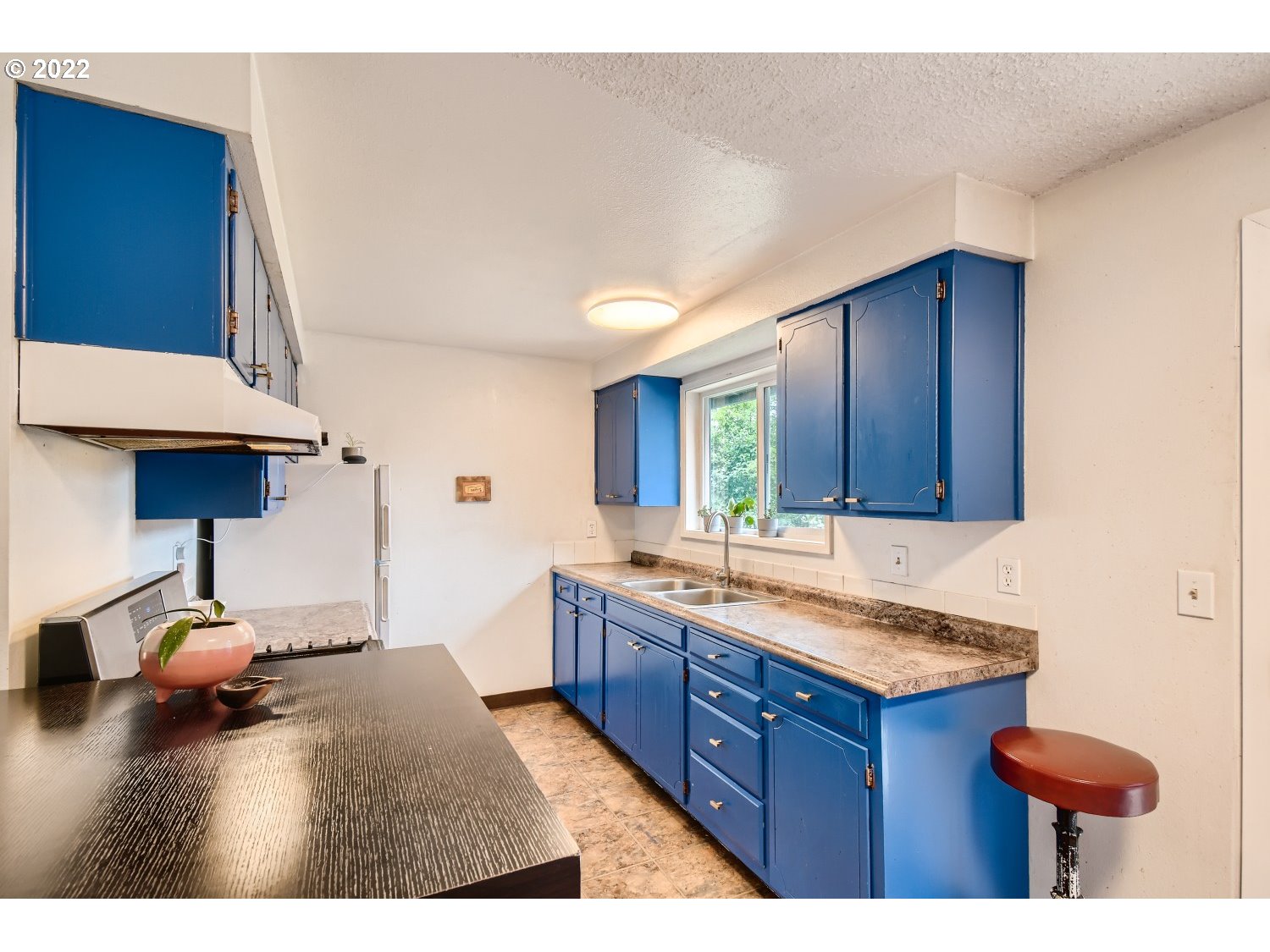 7109 North Sedro Street Portland, OR 97203 - Photo 11 of 28 a kitchen with granite countertop a sink stove and cabinets