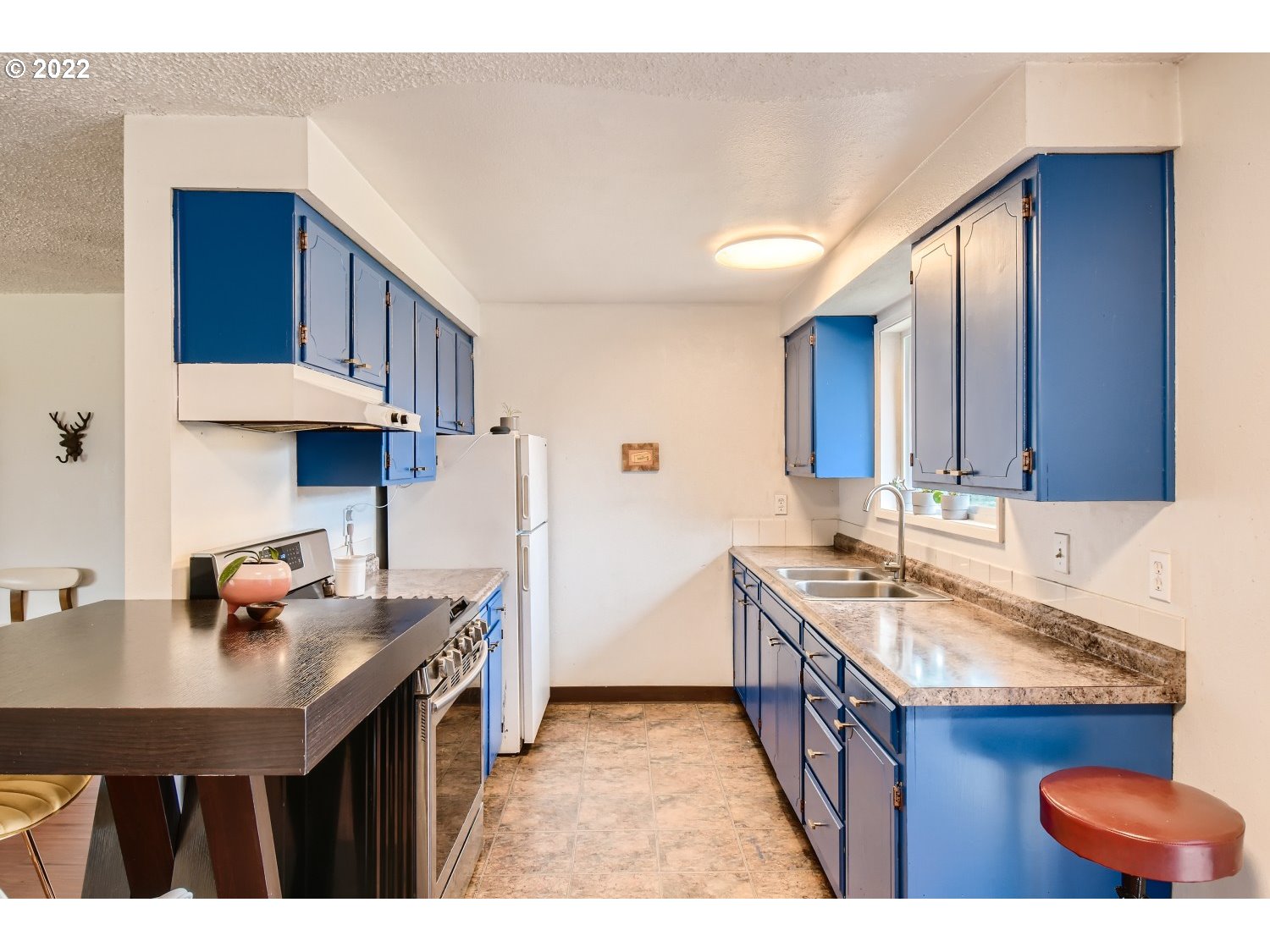 7109 North Sedro Street Portland, OR 97203 - Photo 14 of 28 a kitchen with stainless steel appliances granite countertop a sink a stove and a refrigerator