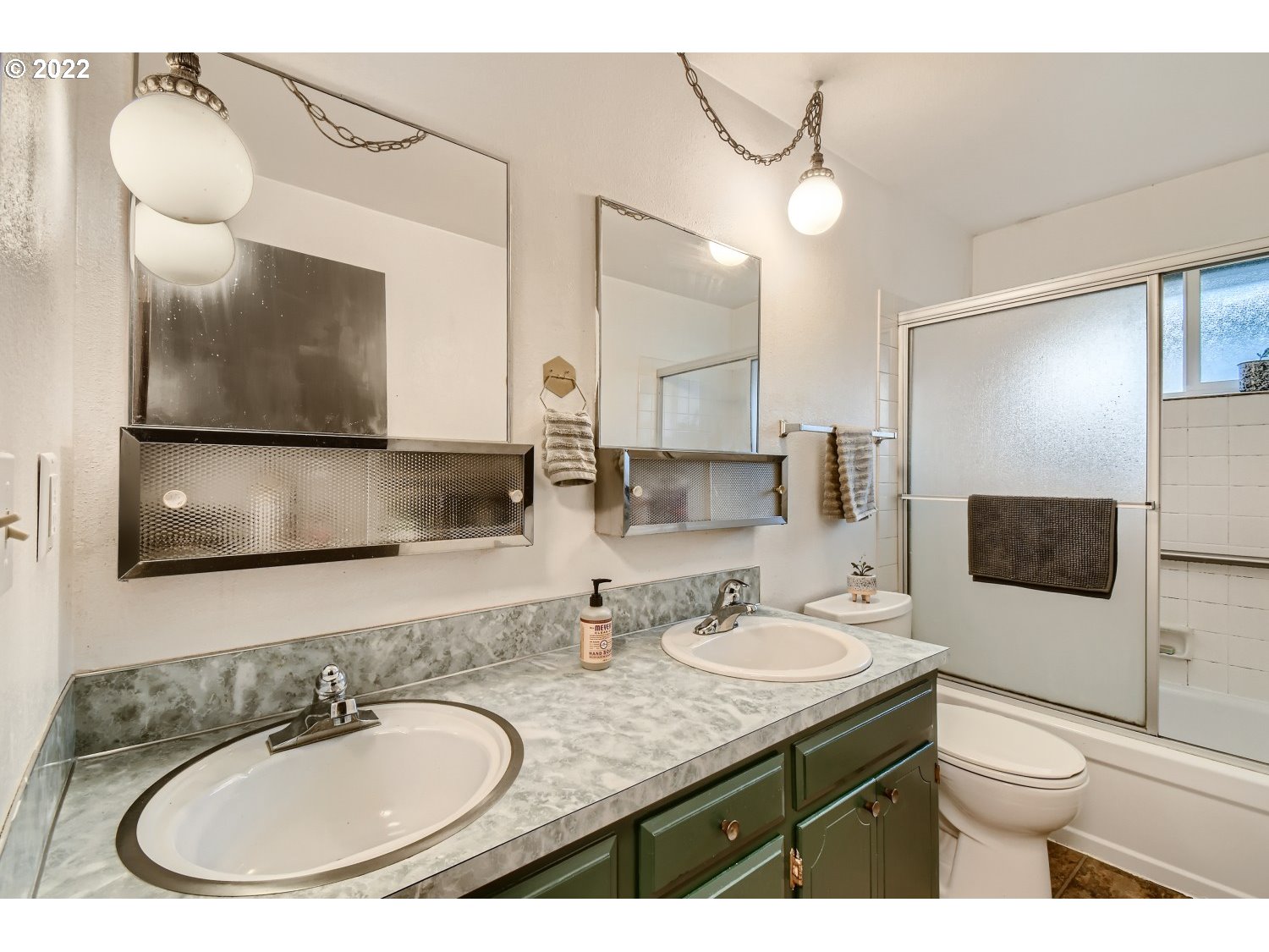 7109 North Sedro Street Portland, OR 97203 - Photo 17 of 28 a bathroom with a granite countertop sink a large mirror and a toilet
