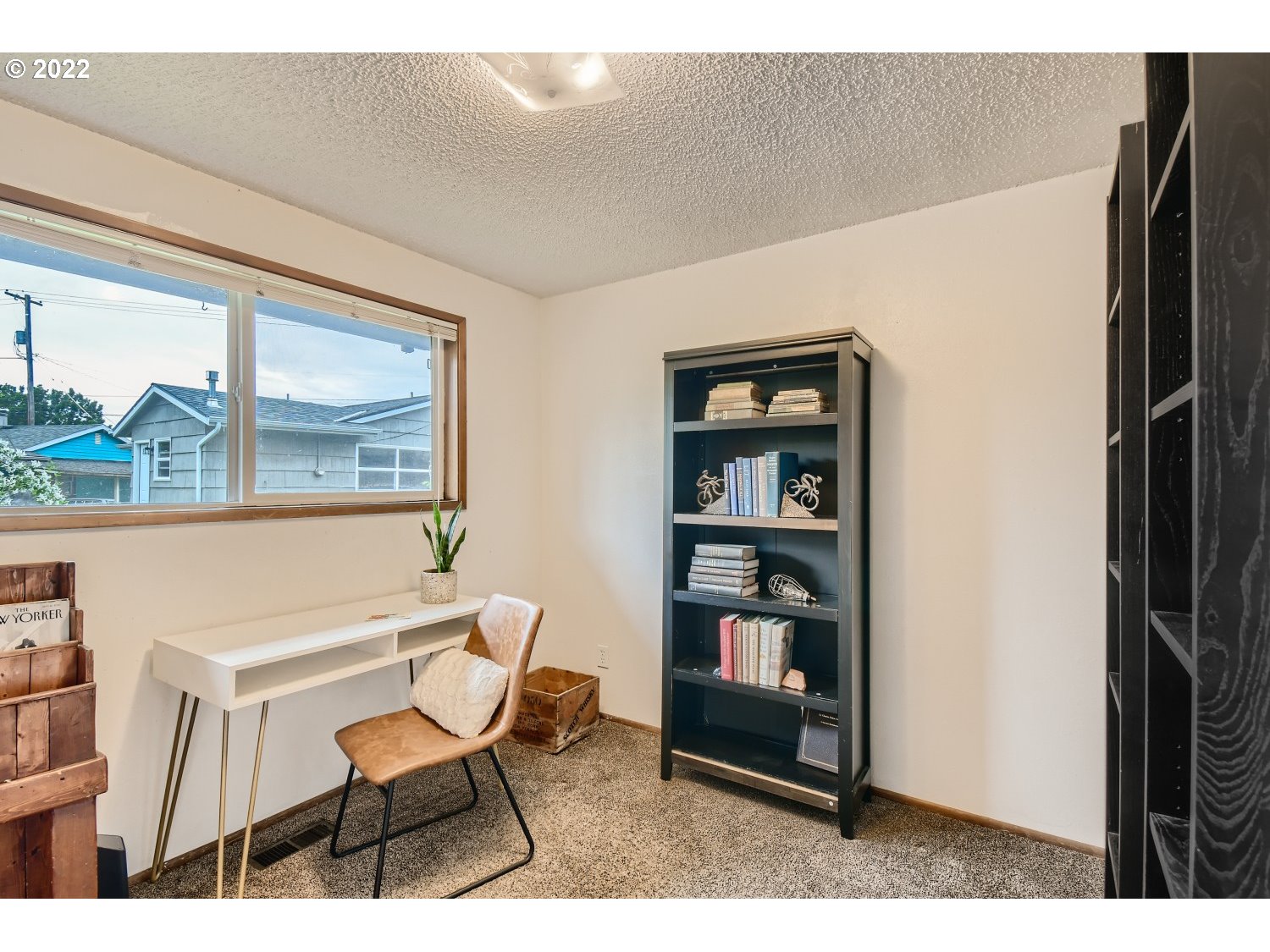 7109 North Sedro Street Portland, OR 97203 - Photo 19 of 28 a living room with furniture a bookshelf and a window