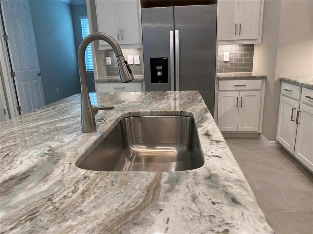 124 Soliera Street Nokomis, FL 34275 - Photo 12 of 43 a kitchen with a refrigerator sink and cabinets