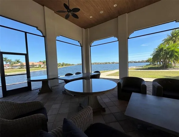a living room with large couches and dining table with garden view