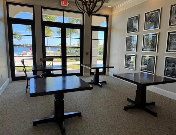 a living room with furniture pool table and windows