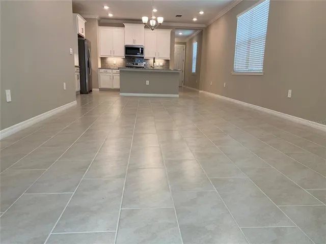 a view of kitchen with granite countertop a sink and a stove top oven