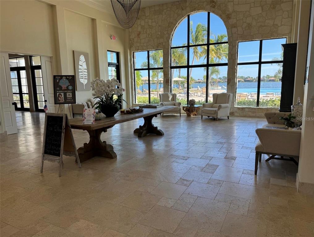 124 Soliera Street Nokomis, FL 34275 - Photo 31 of 43 a living room filled with furniture and a floor to ceiling window